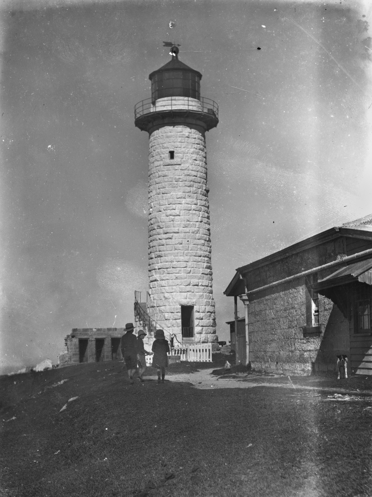 Three young children playing in the shadows of Cape Moreton Lighthouse, Moreton Island, ca. 1912