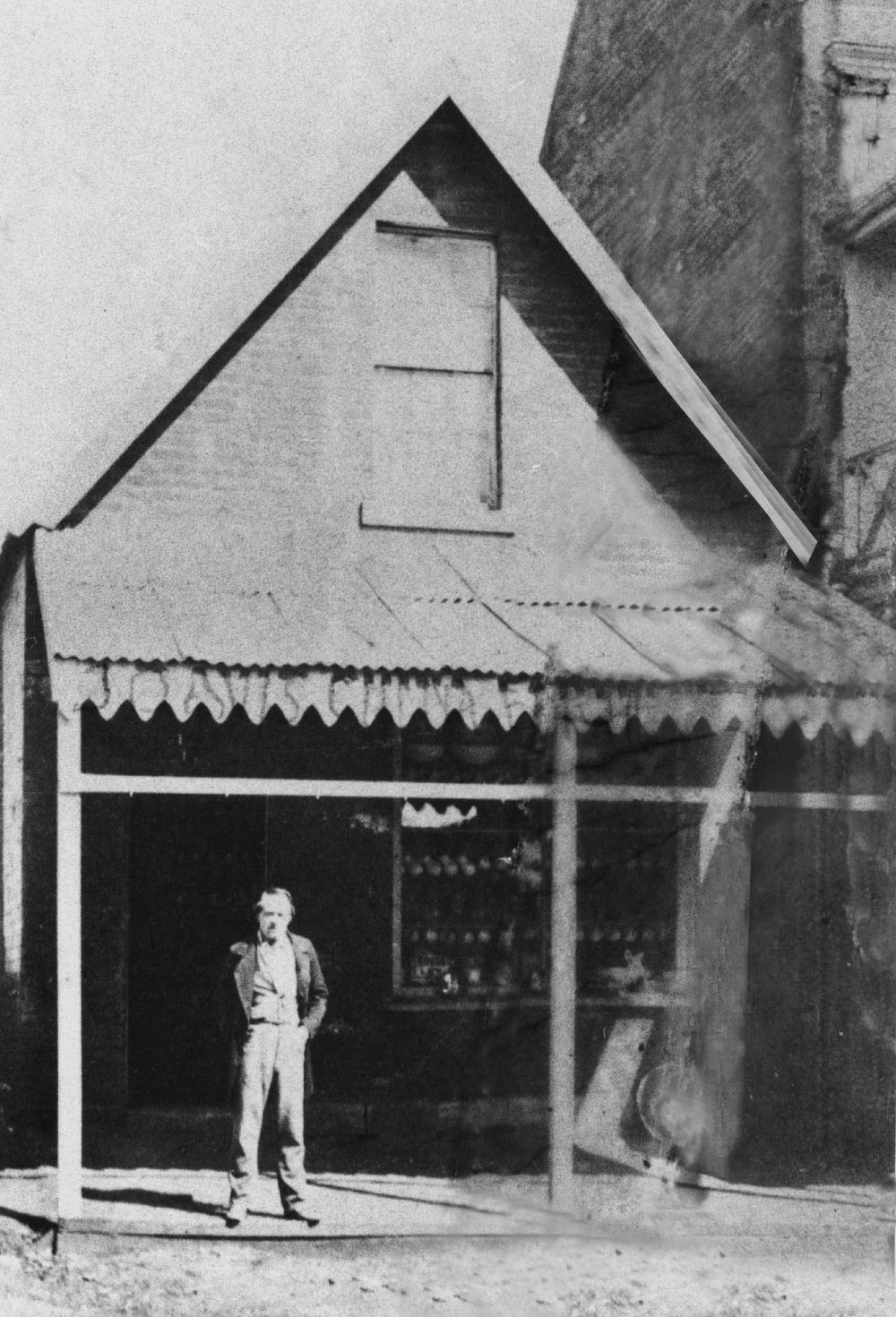James Davis poses in front of his crockery store, George Street, Brisbane, ca. 1872