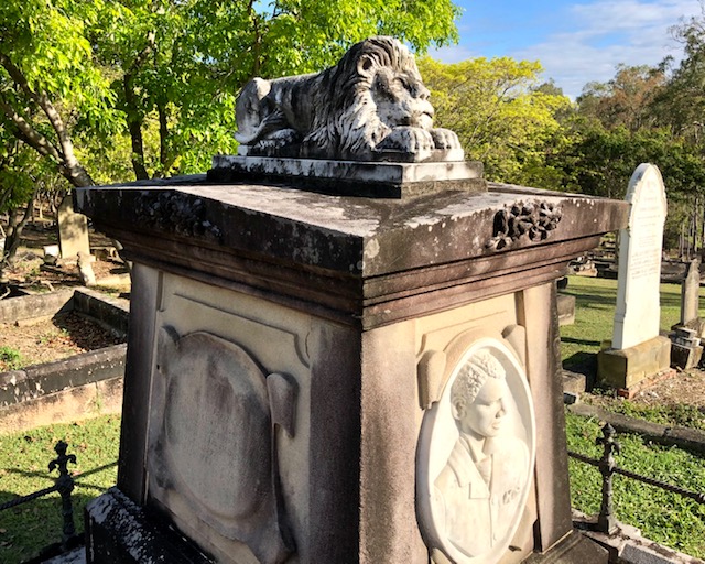 Lion carving on top of a headstone