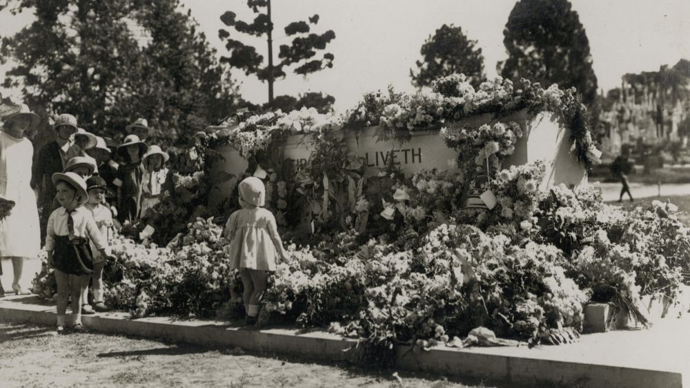 Small children looking at wreaths laid at the memorial on Anzac Day, Toowong Cemetery, Brisbane, 1924